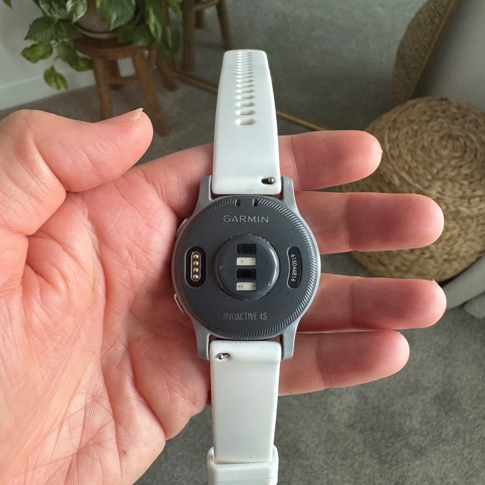 garmin vivoactive 4s white smartwatch with black charger cable